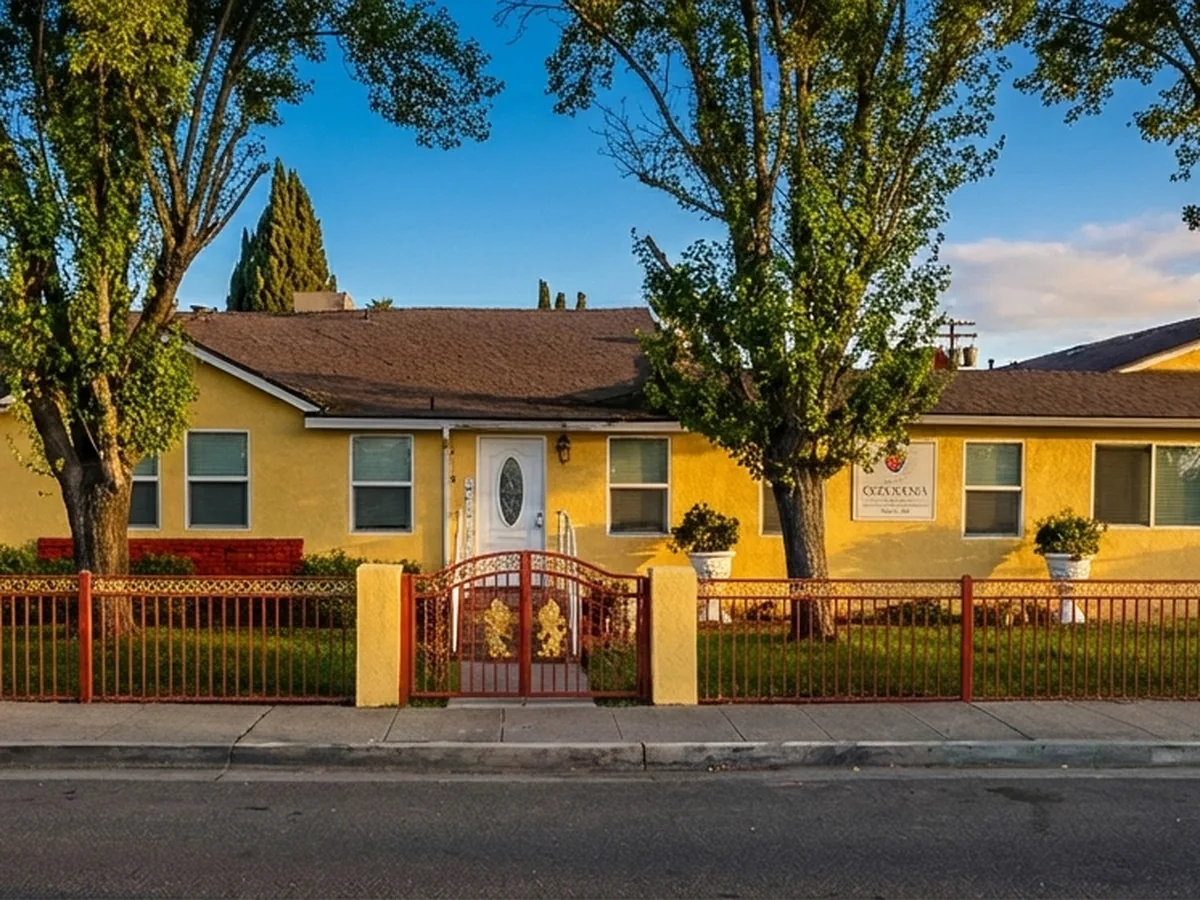 Golden Years Chowchilla senior living community exterior — yellow stucco residence at golden hour